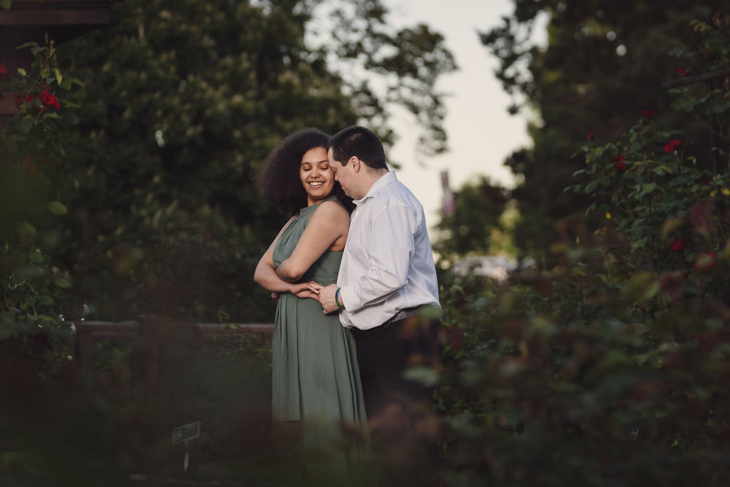 RJ and Maya surrounded in a romantic setting at Point defiance park in Tacoma.