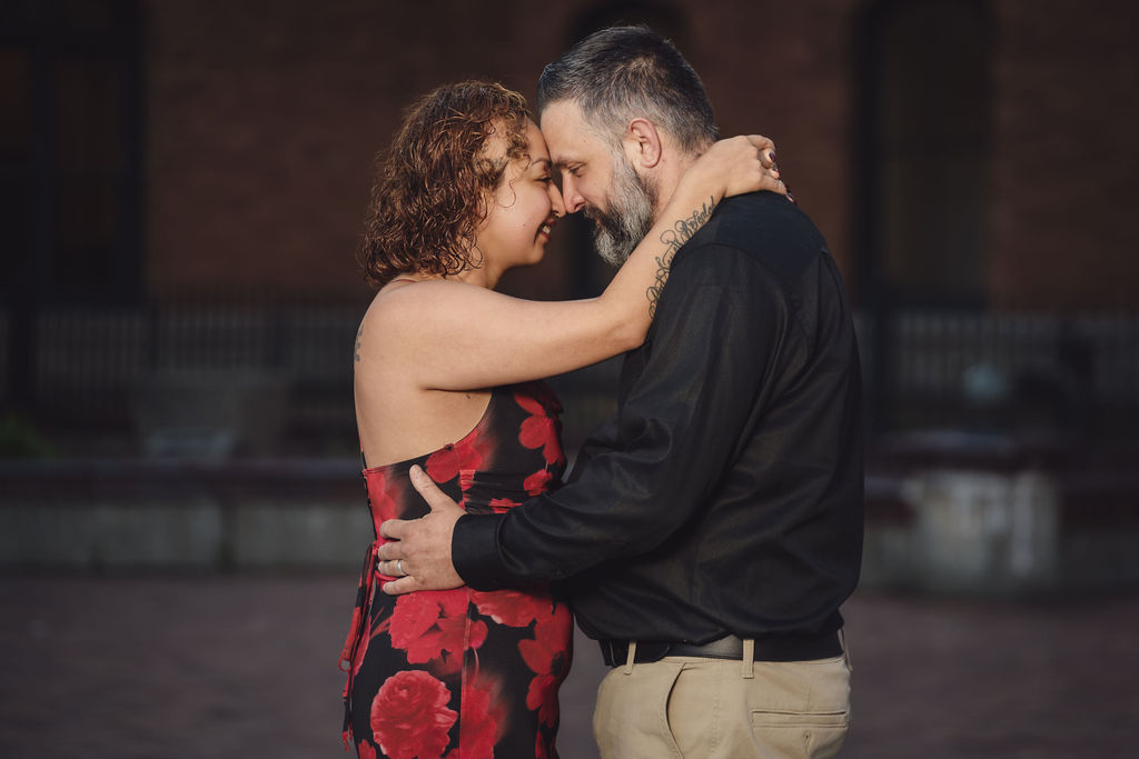 Engaged couple laughing together forehead to forehead at Stadium High School in Tacoma, a connection focused engagement photo