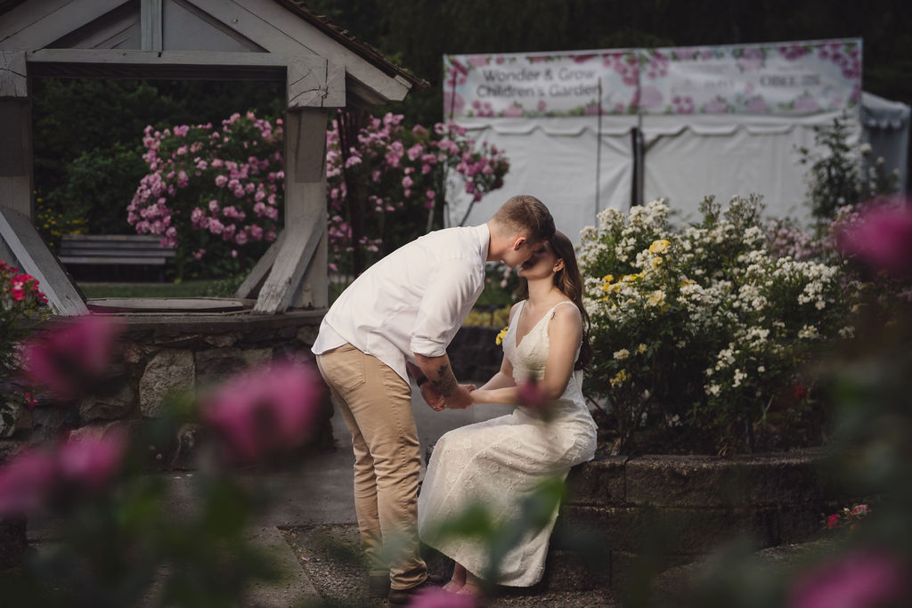 Engaged couple walking the rose garden paths at Point Defiance in Tacoma