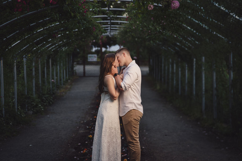 Romantic engagement portrait in a Tacoma rose garden at sunset