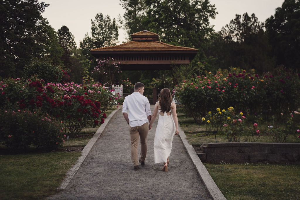 Close embrace during a rose garden engagement session in Tacoma