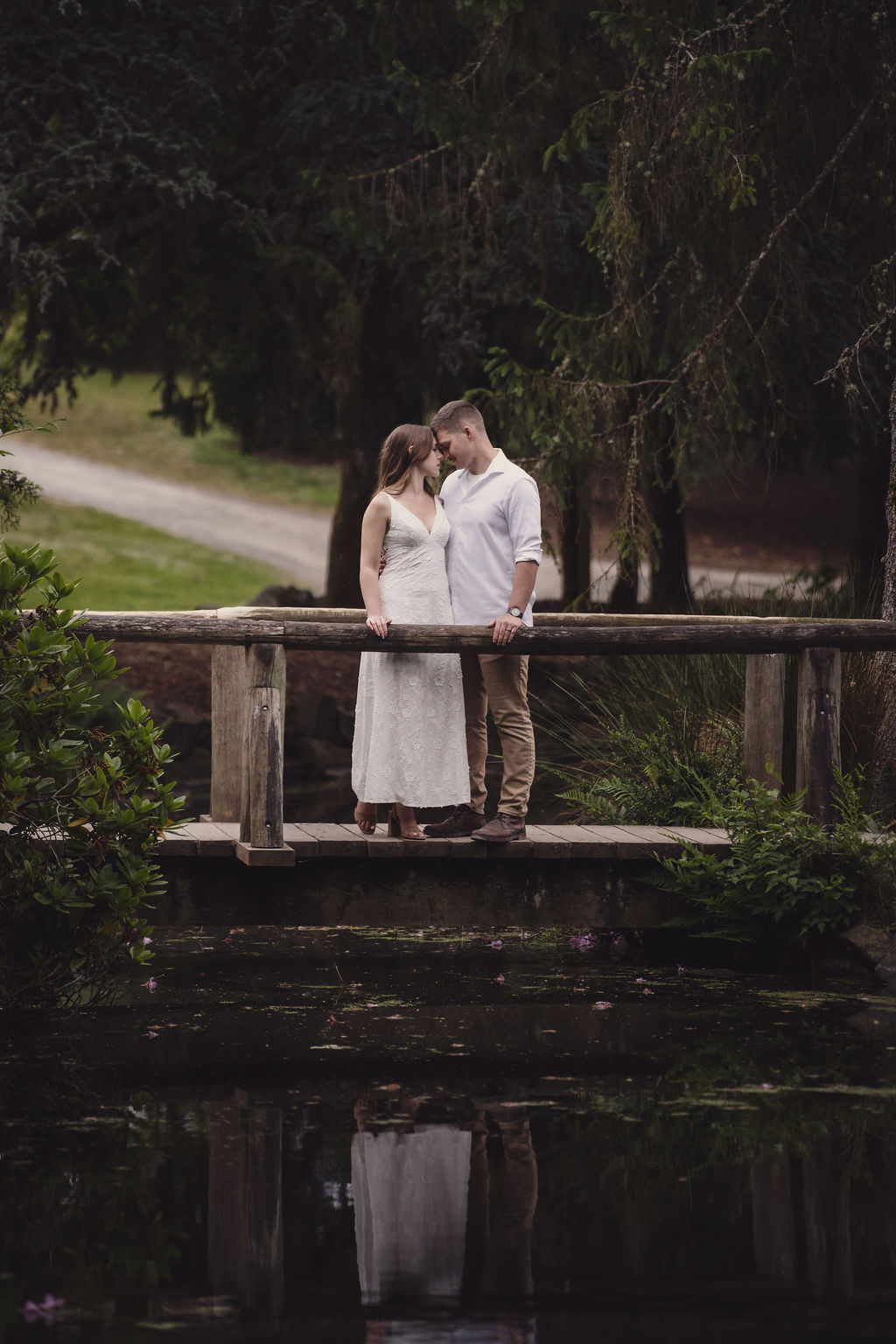 Engaged couple among white roses in Tacoma Washington
