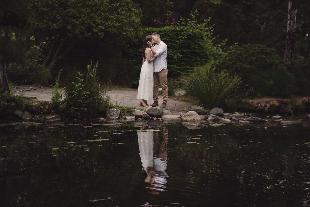 Couple kissing in the rose garden at golden hour in Tacoma