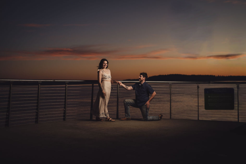 Engaged couple laughing during golden hour at Chambers Bay