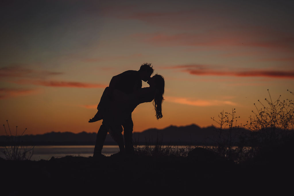 Bride to be smiling on the shoreline at sunset during a Chambers Bay engagement session near Tacoma
