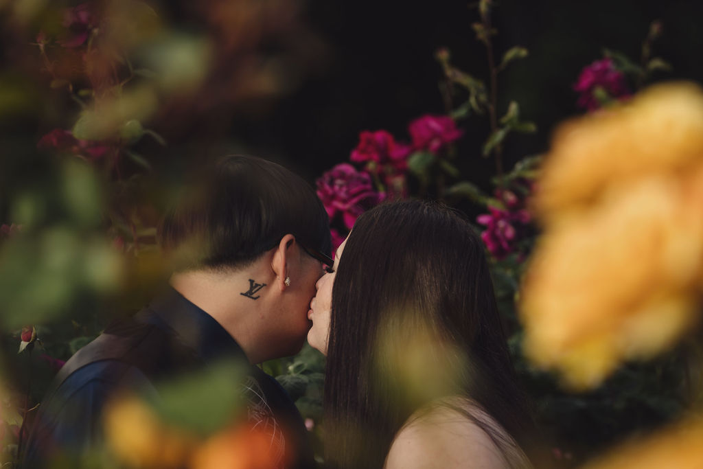 Wide engagement portrait in the rose garden at Point Defiance Park, Tacoma, warm golden hour light, Nautical Moments Photography
