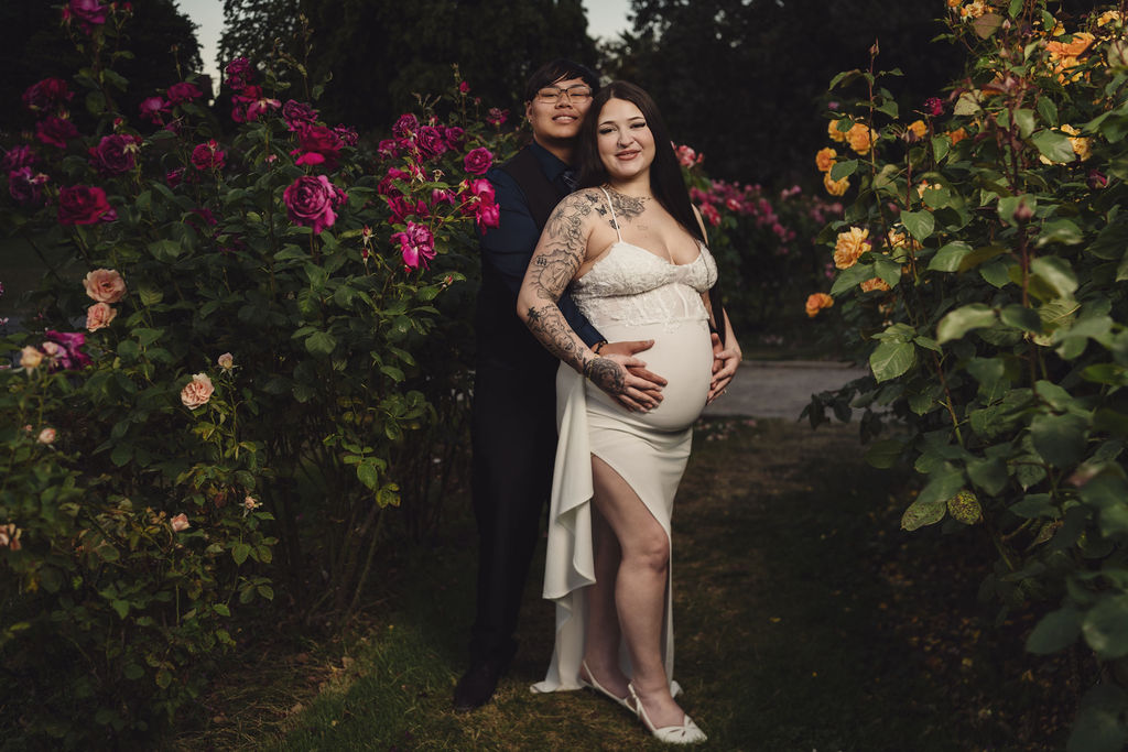 Couple in formal attire sharing a romantic moment at Point Defiance Rose Garden in Tacoma Washington