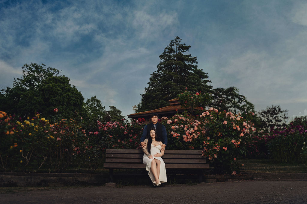 Engagement portrait at Point Defiance Rose Garden with blooming roses and warm evening light in Tacoma