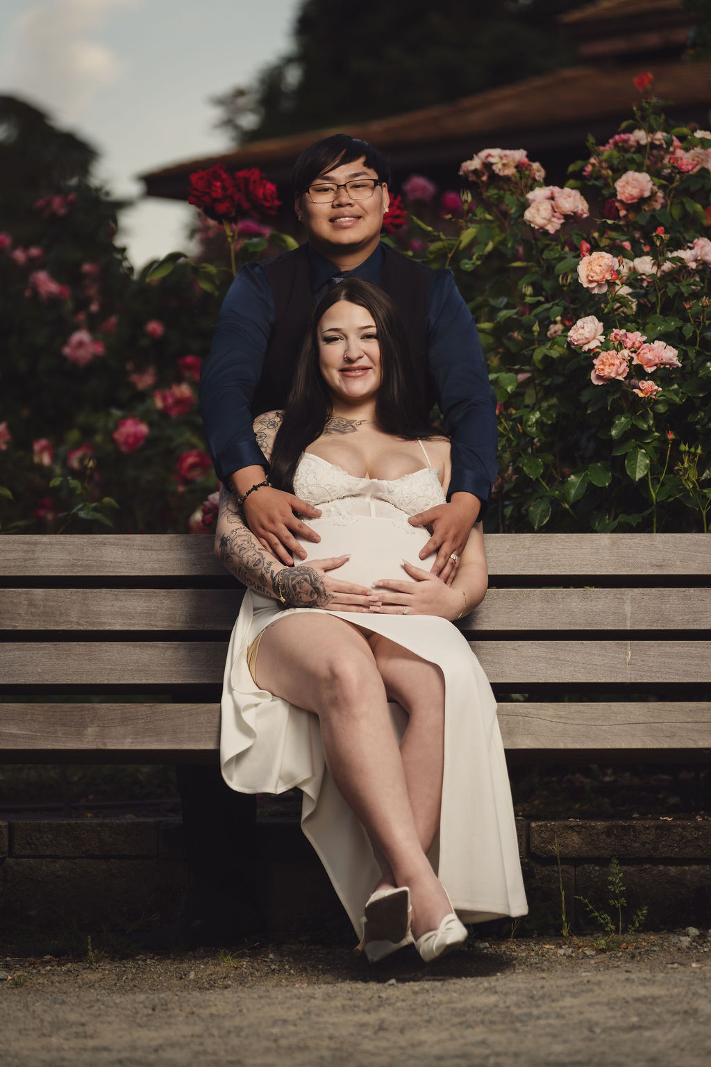 Close romantic engagement portrait among blooming roses at Point Defiance Rose Garden, Tacoma, Nautical Moments Photography