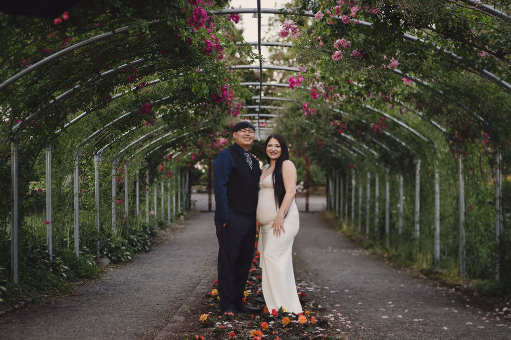 Engaged couple embracing among roses at Point Defiance Park in warm afternoon light, Tacoma WA, Nautical Moments Photography