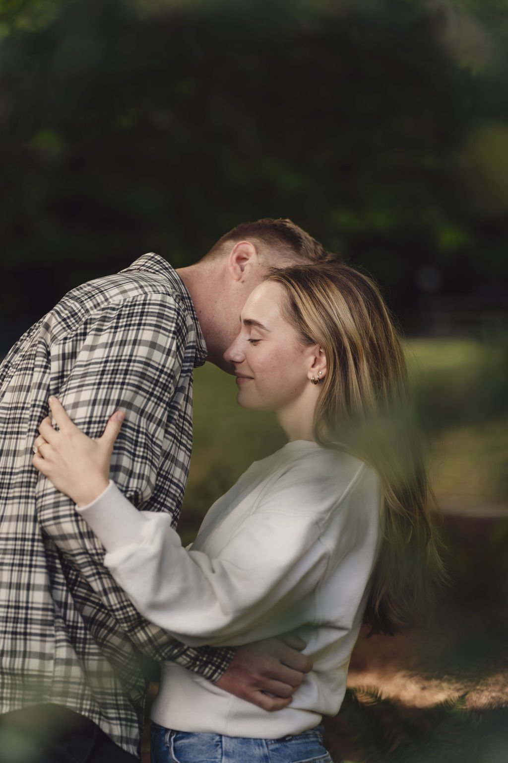 Engagement photography in dappled evening light at Scenic Beach State Park in Kitsap County