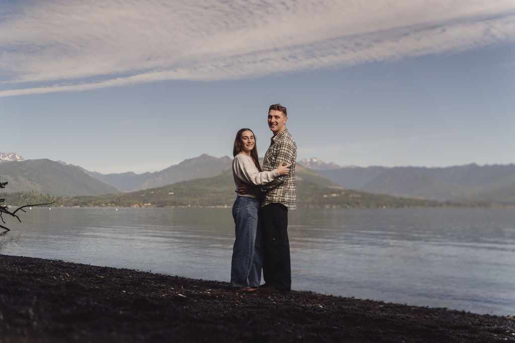 Engaged couple on the quiet Hood Canal shoreline at dusk at Scenic Beach State Park