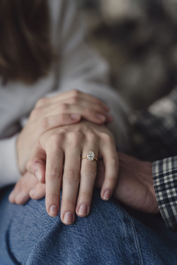 Close up of an engagement ring resting on denim during a Scenic Beach State Park engagement session in Seabeck