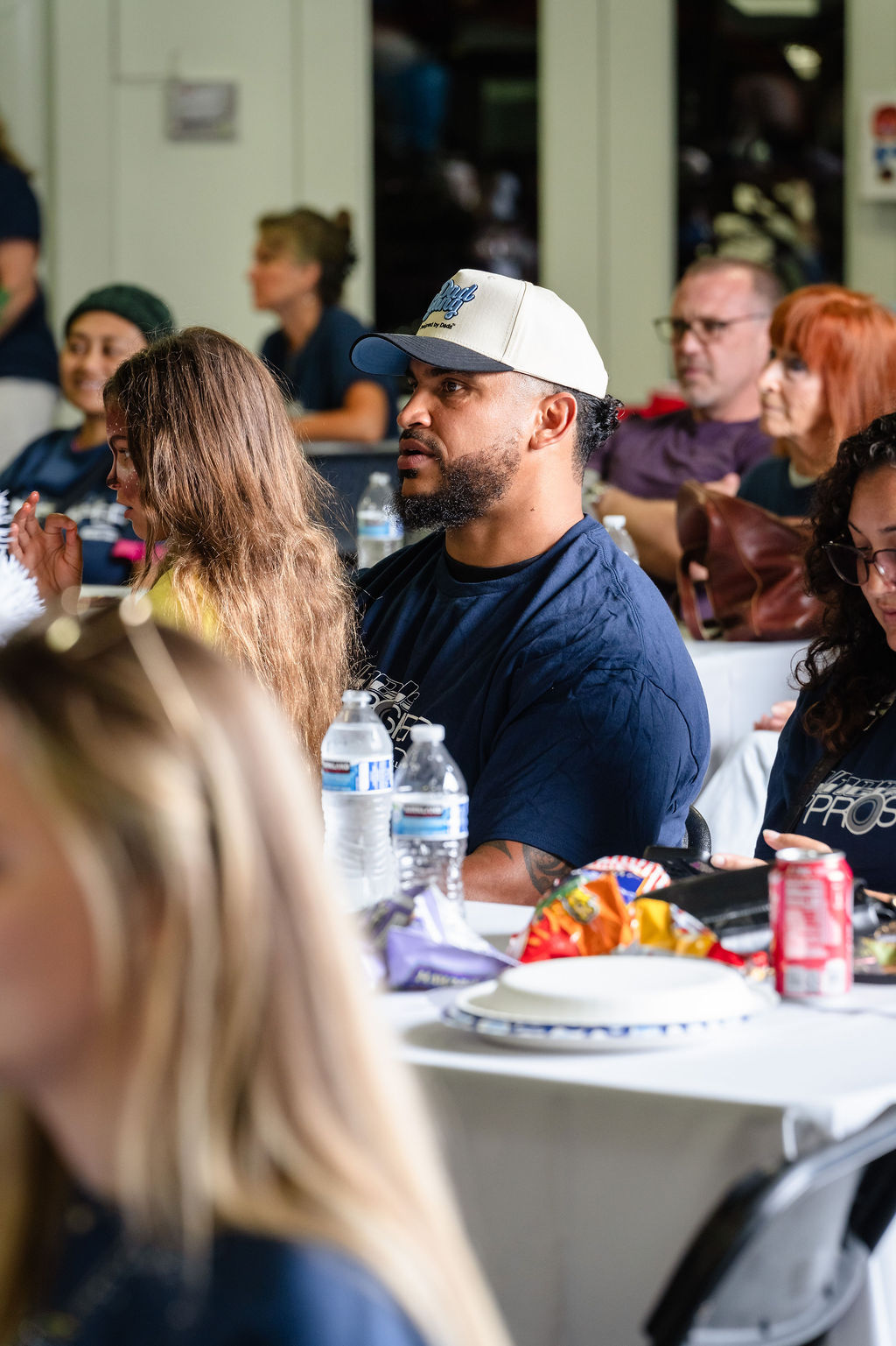 Seated guests with snacks and water watching the program at a Tacoma charity event