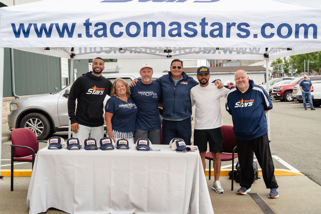 Local business community members gathered under a sponsor tent at the Tacoma car giveaway
