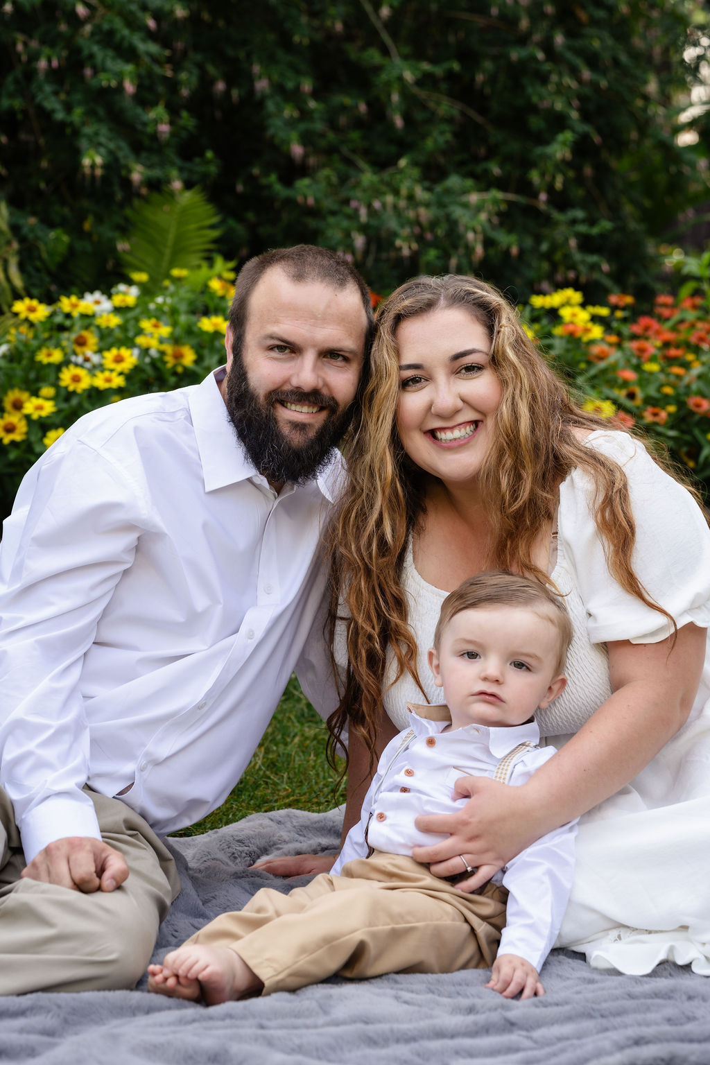 Close family portrait of parents and their son in the Tacoma flower gardens at Point Defiance
