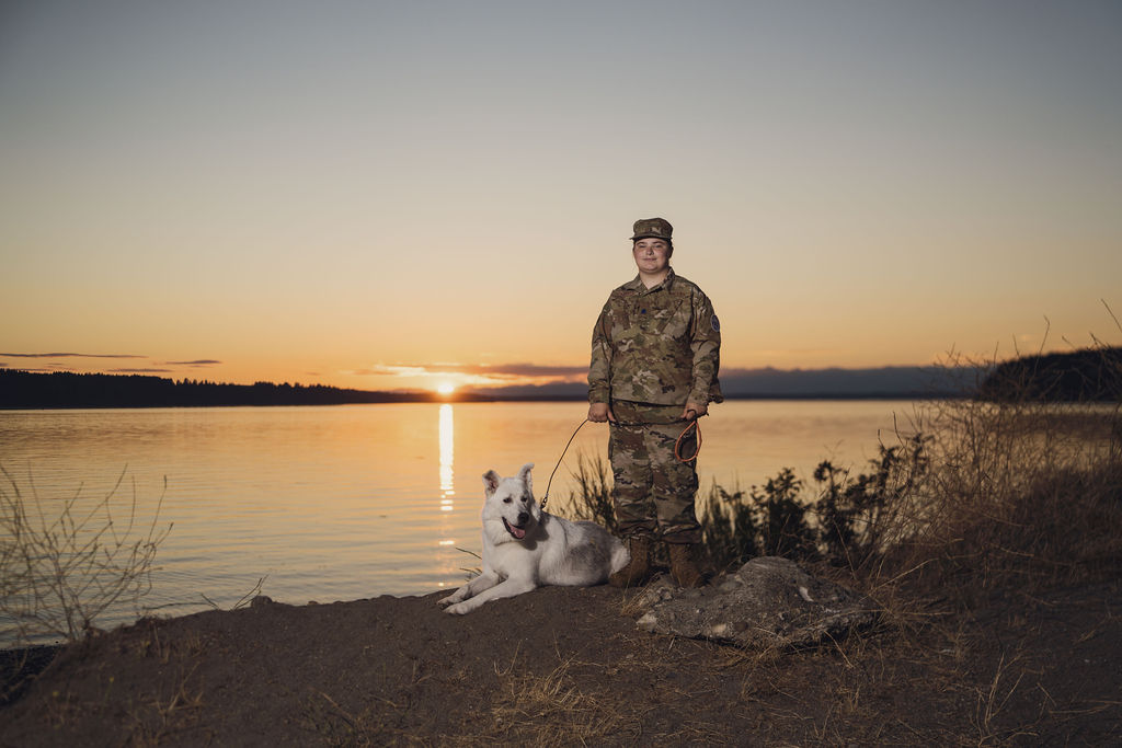 Tacoma senior photographer portrait of a senior in Air Force Junior ROTC uniform with her white husky on the beach as the sun sets over Puget Sound