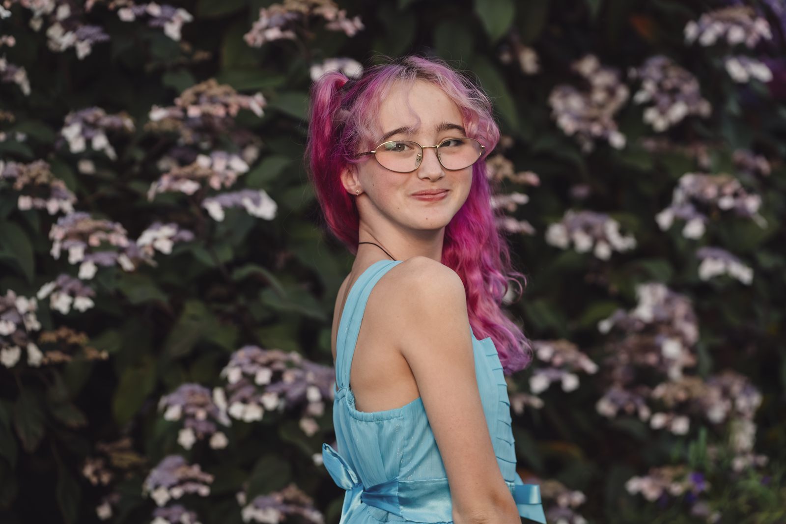 Teen portrait in front of a hydrangea wall at Point Defiance Rose Garden in Tacoma