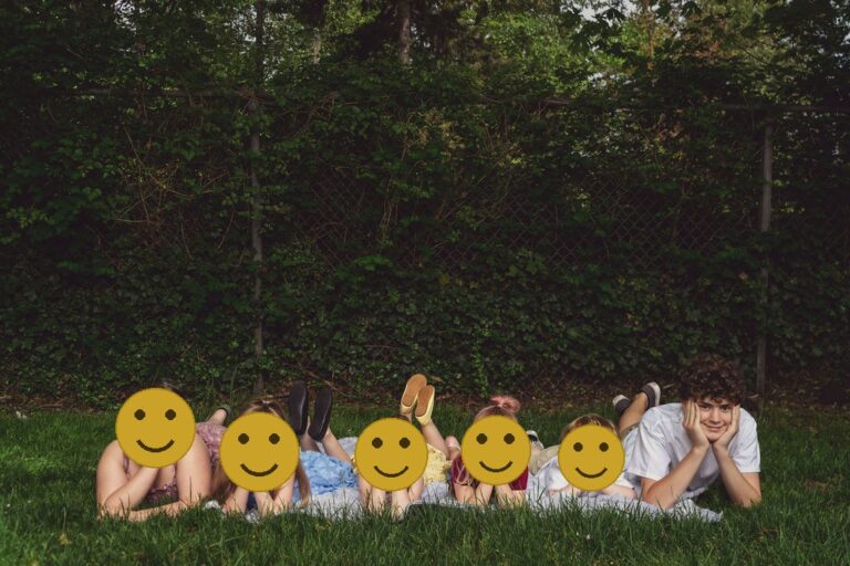Children propped on their hands in the grass at a Kitsap County park