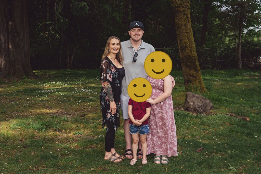 Family of four during an outdoor family session at a Kitsap County park, faces covered for privacy