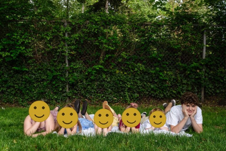 Kitsap County cousins lying in a row in the grass during an extended family park session
