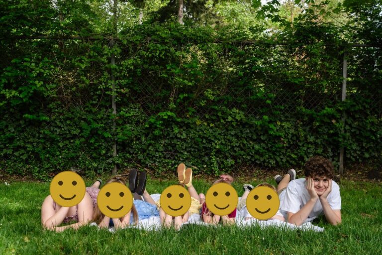 Group of kids lying in the grass during a relaxed Kitsap County family photo session