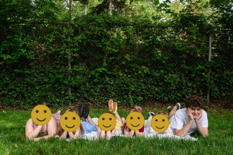 Kids lying in the grass at a Kitsap County park during a family photo session
