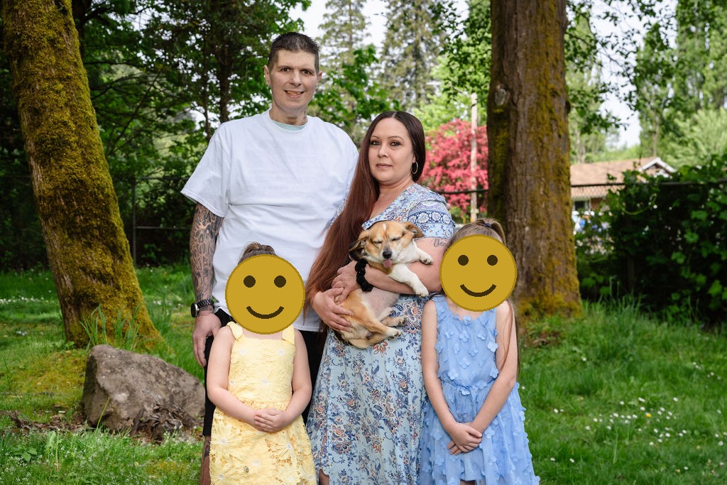 Family with two daughters and their dog at a green Kitsap County park, faces covered for privacy