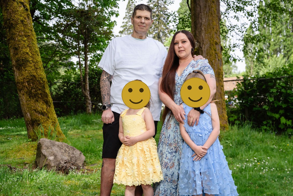 Family of four with their dog during a Kitsap County park session, faces covered for privacy