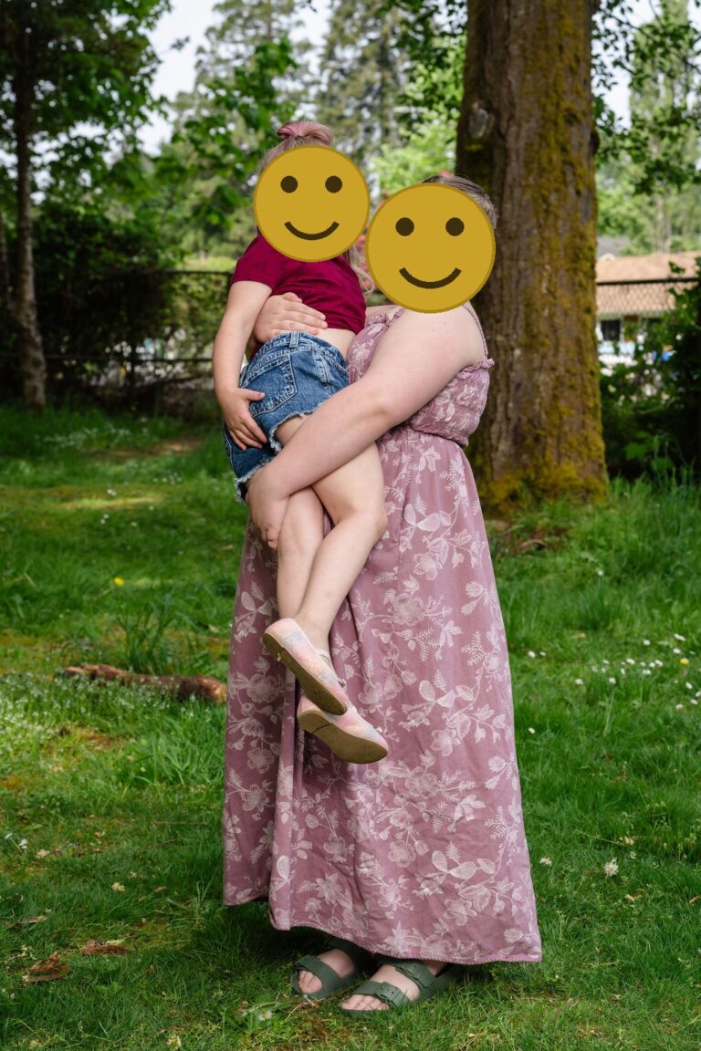 Older sister holding her little sister during an extended family session at a Kitsap County park