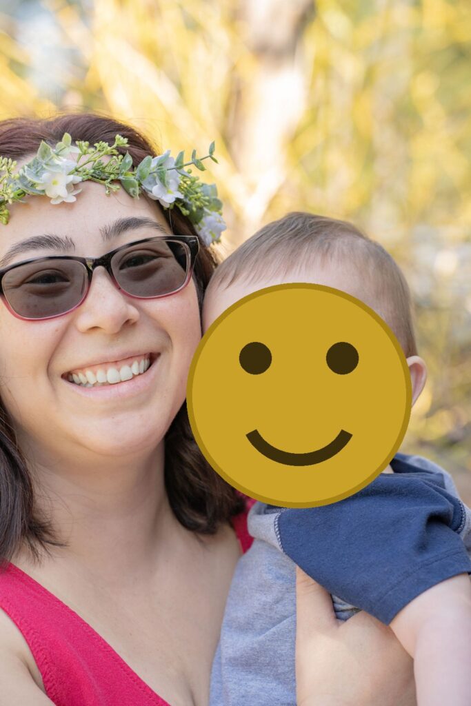 Close portrait of a mother and her baby boy outdoors at a Kitsap County family session, faces covered for privacy