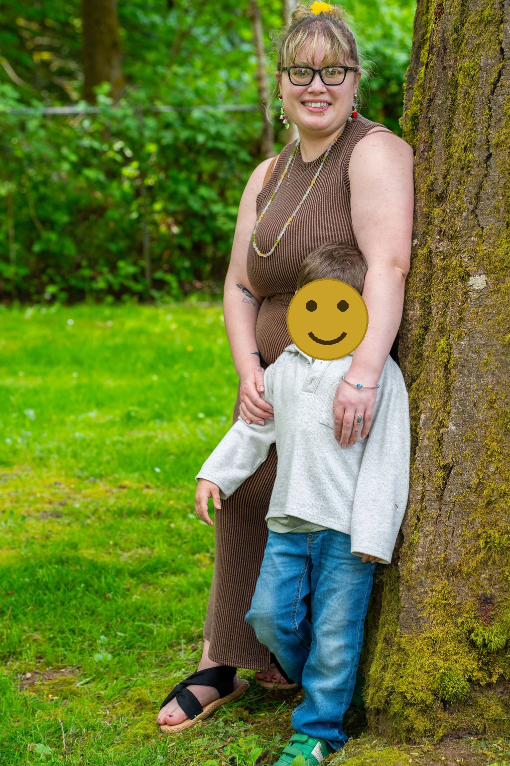 Mother and her young son leaning against a mossy tree during a Kitsap County park session