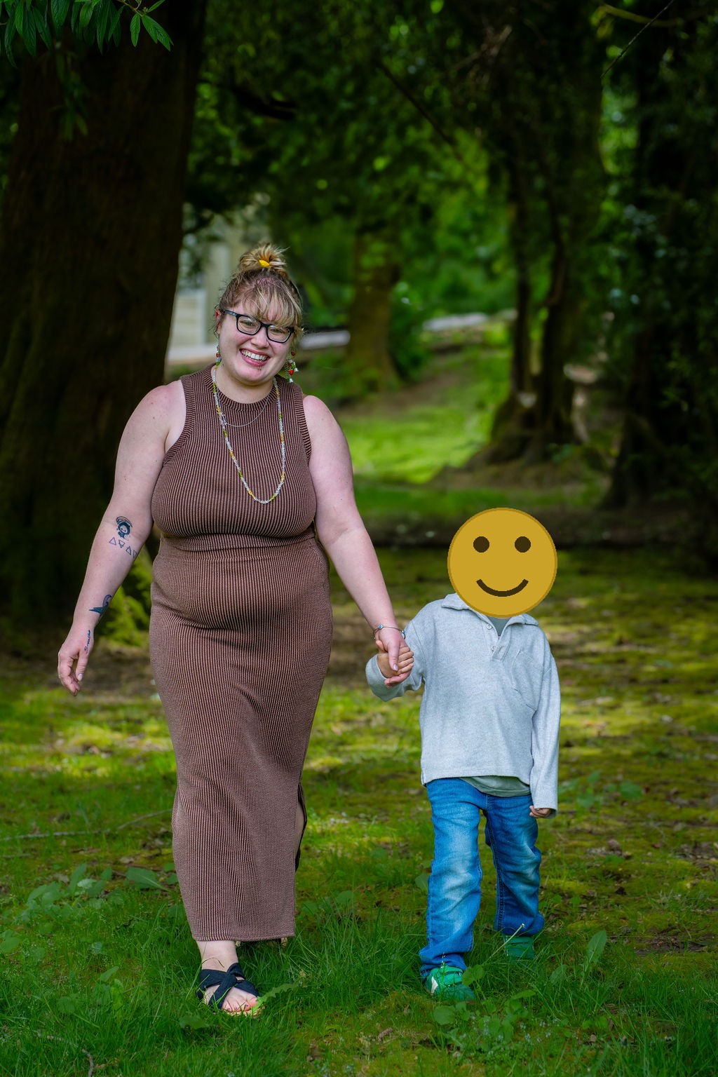 Mother and son walking down a tree lined path at a Kitsap County park