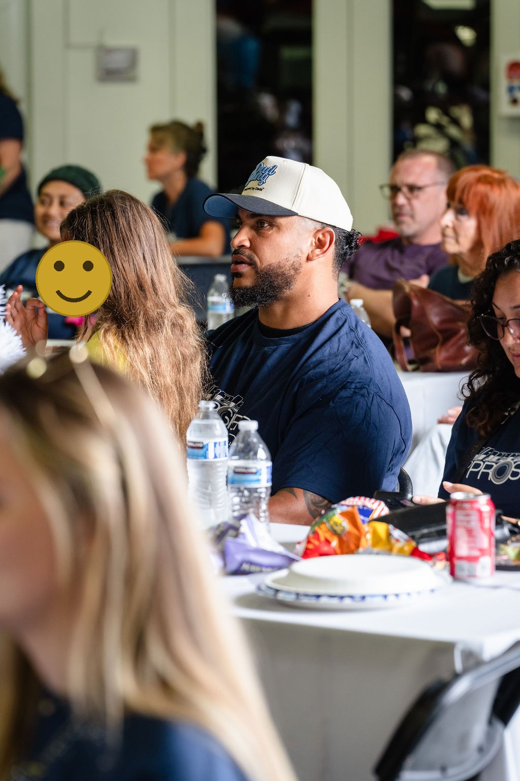 Seated guests with snacks and water watching the program at a Tacoma charity event