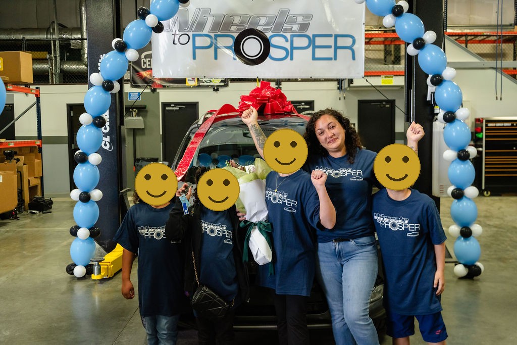 Mother and four daughters cheering in front of a donated car in Tacoma