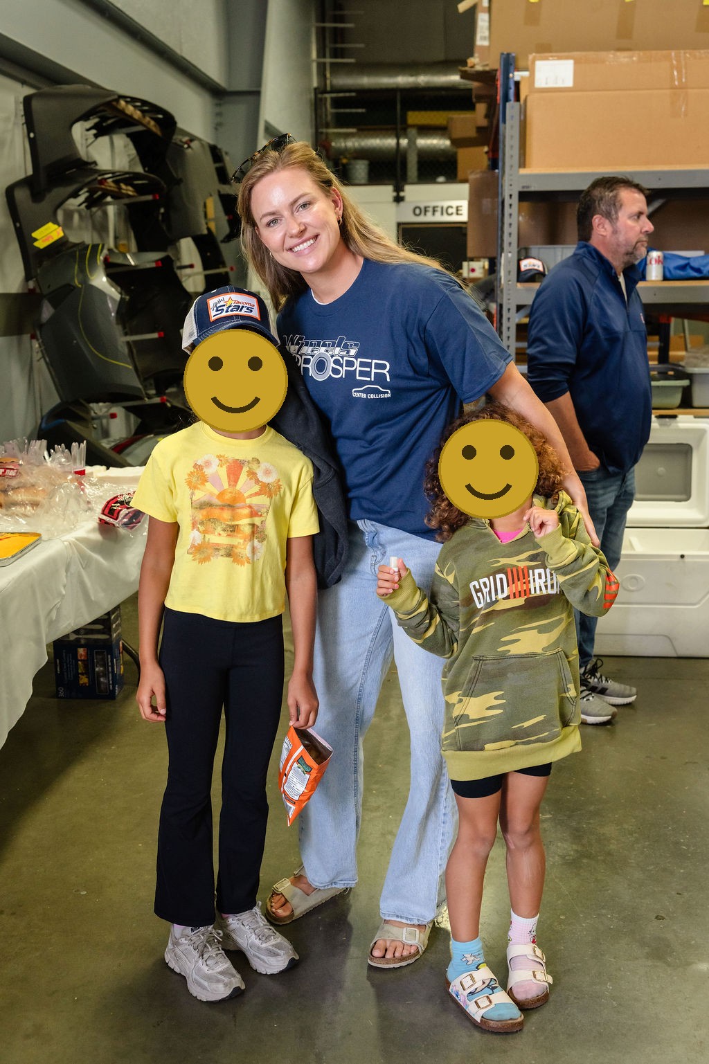 Woman and two girls with painted faces smiling at a Tacoma community charity event