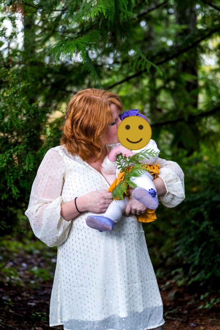 Mother kissing her daughter during an at home family session in Kitsap County