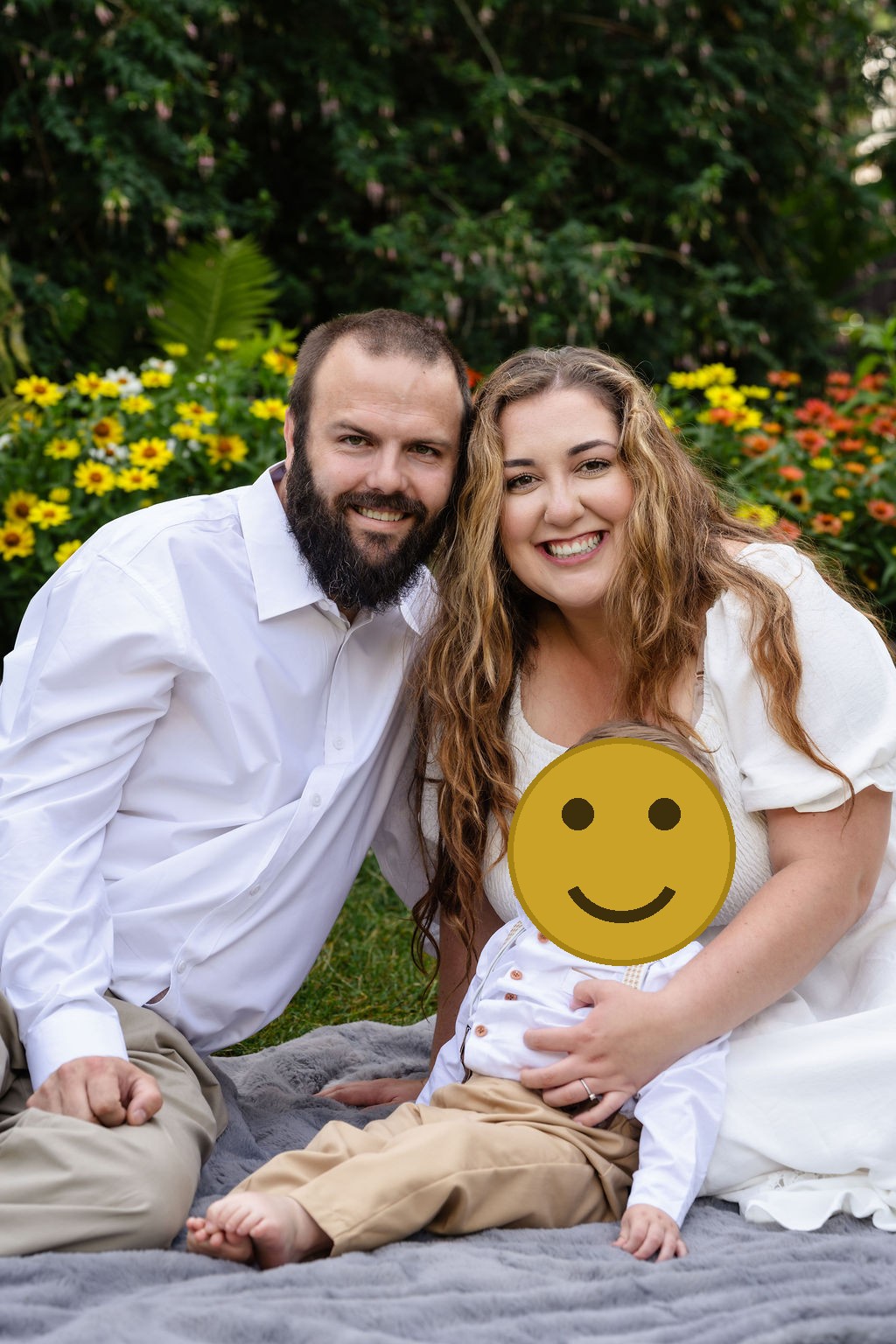 Close family portrait of parents and their son in the Tacoma flower gardens at Point Defiance