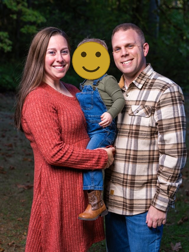 Family photographed among evergreens at a Kitsap Christmas tree farm, childs face covered for privacy