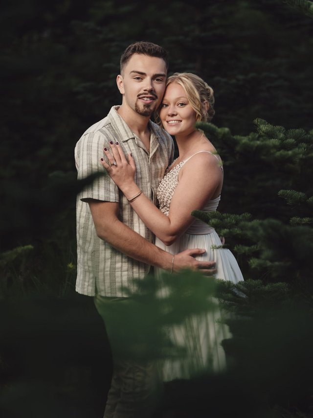 Couple in the firs at a Kitsap County Christmas tree farm