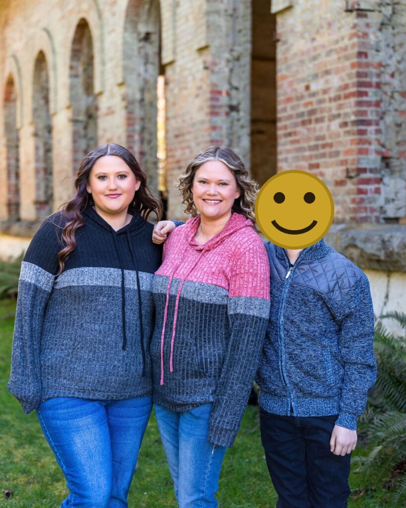 Mother and two children in coordinated timeless outfits during a family photo session at Manchester State Park in Kitsap County, Washington