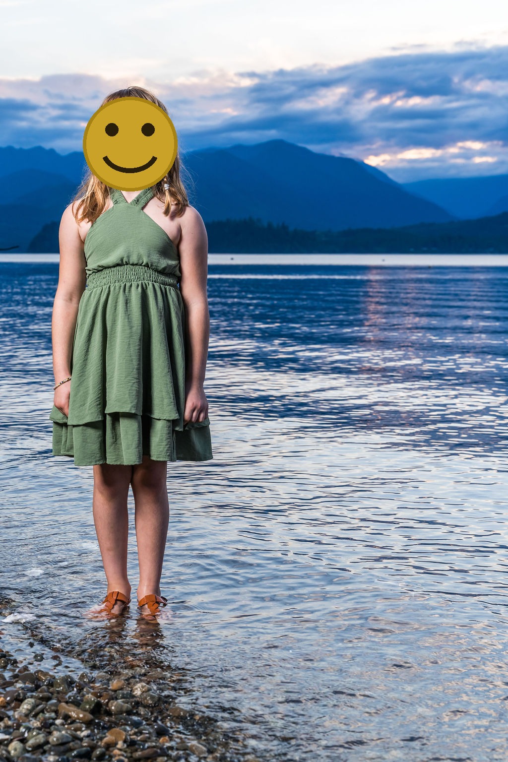 Young girl at the water's edge at sunset during a family beach photo session in Washington