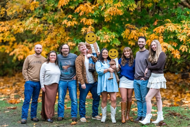 Extended family portrait among golden fall foliage during an autumn family photo session in Kitsap County, Washington, faces covered for privacy