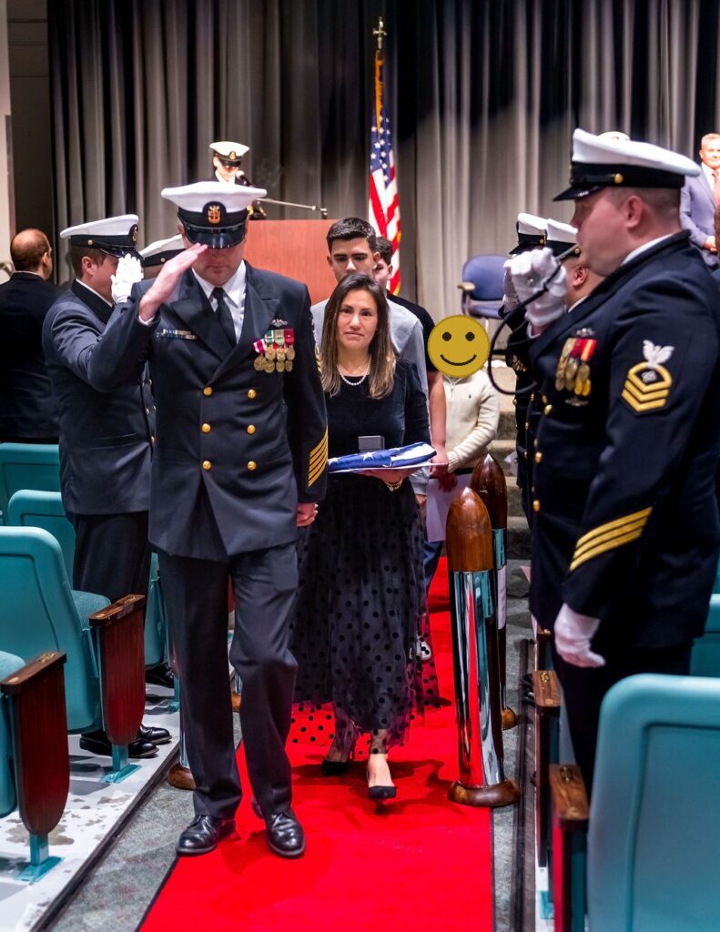 Master Chief exiting with family during ceremony.