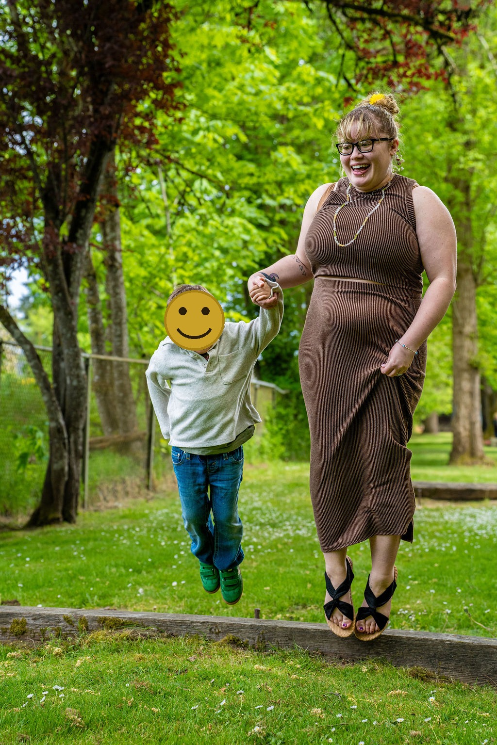 Family photo session with a mother and son jumping and laughing at a park in Kitsap County, Washington