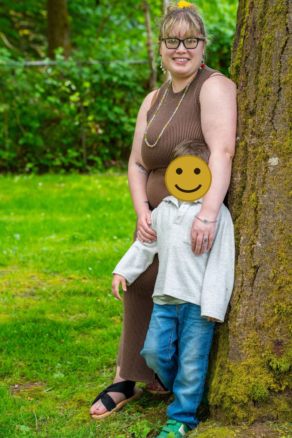 Family photo session with a mother and her son beside a mossy tree at a park in Kitsap County, Washington