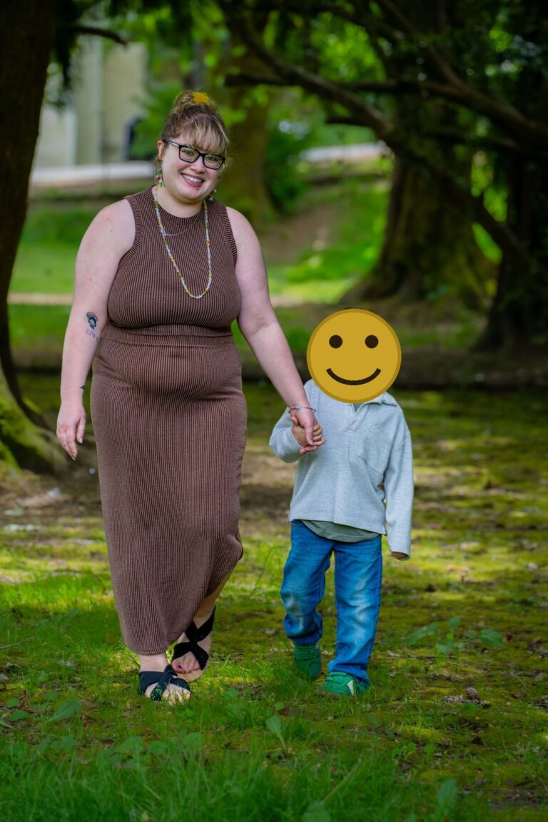 Mother and son walking hand in hand under the trees at a Kitsap County park. family photos park Kitsap County